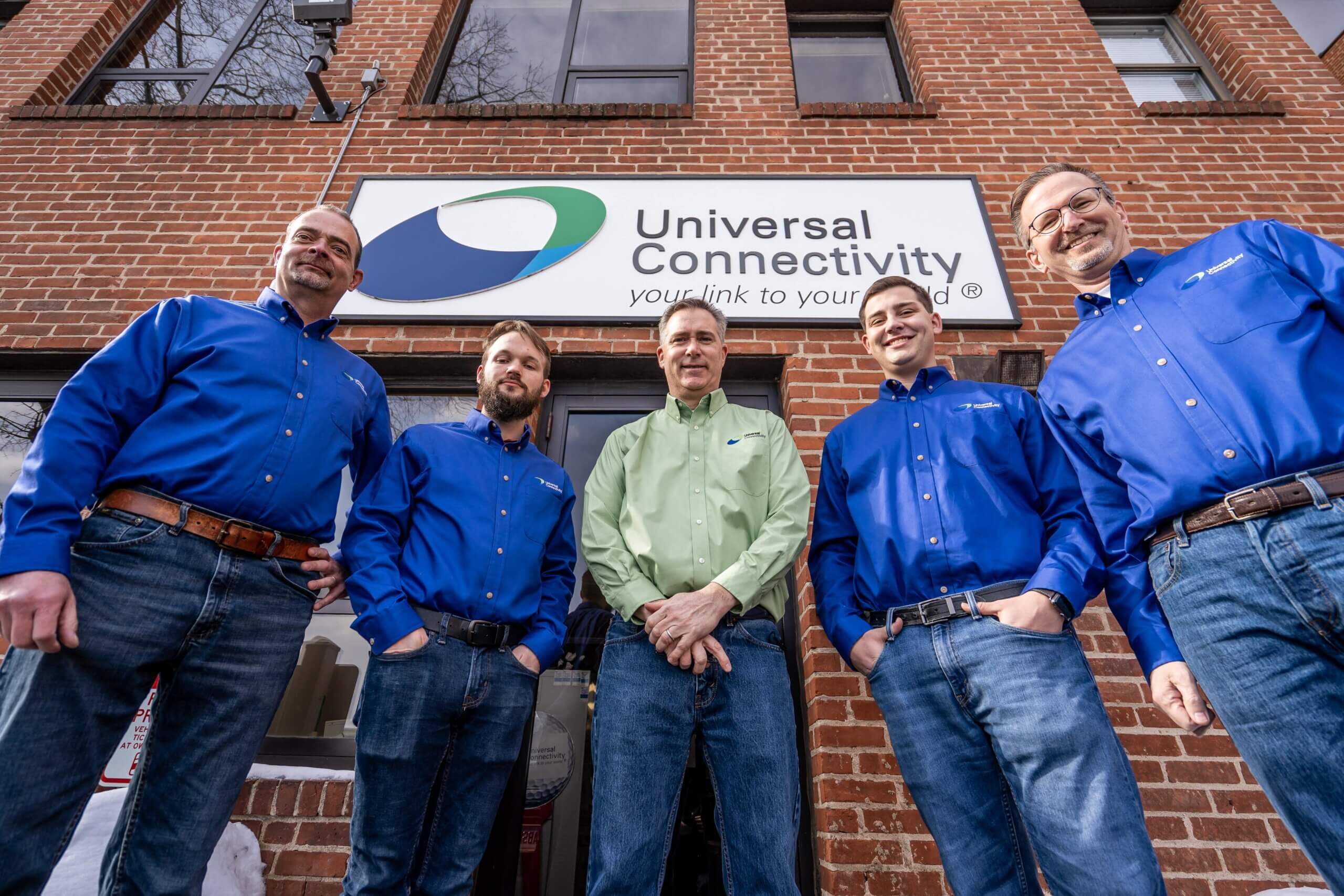 universal connectivity hero landscape images 6 Universal Connectivity team members outside of building